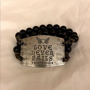 “Love Never Fails” bracelet.